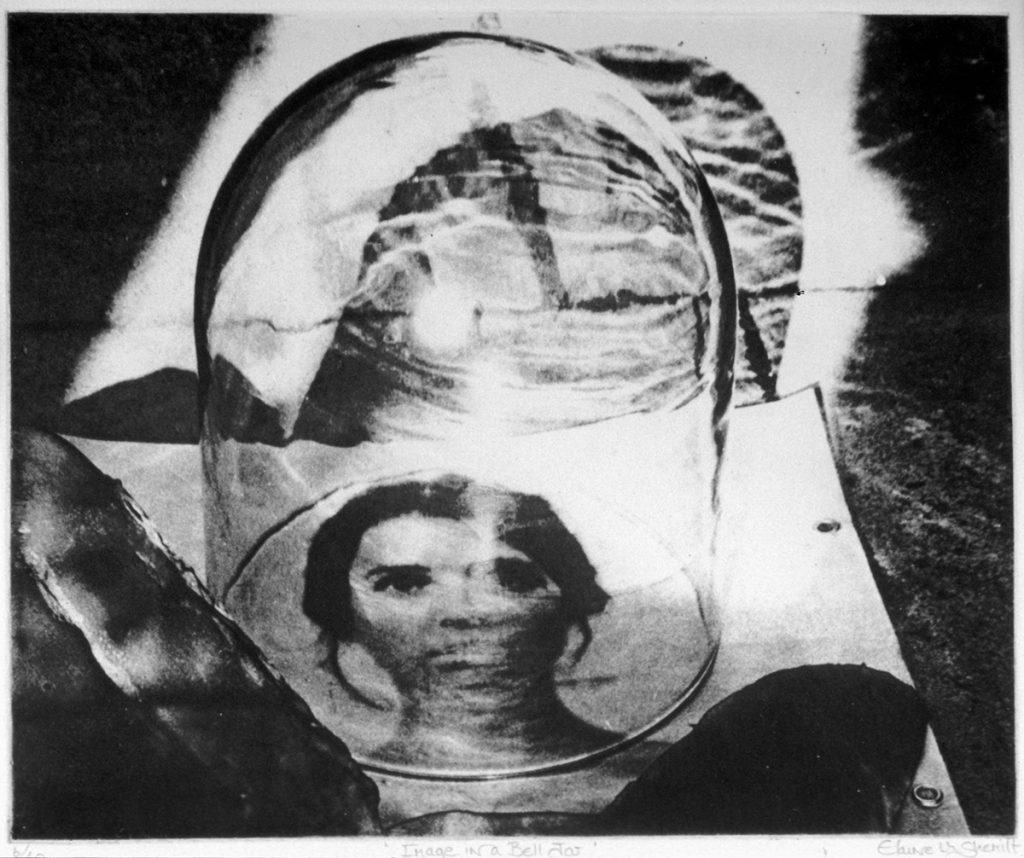 Black and white photograph of a bell jar resting on top of a photograph of a woman.