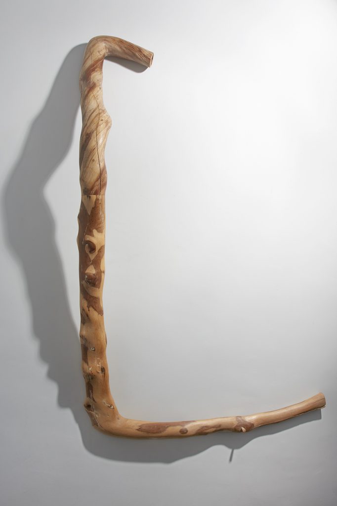 Wooden sculpture made of mulberry and yew wood on a white background.